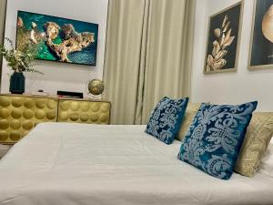 Schlafzimmer mit einem Bett mit blauen und weißen Kissen in der Unterkunft Ô portes du Palais in Avignon