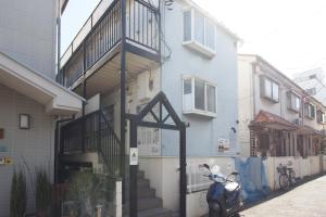 a scooter parked in front of a building at Kaku Studio Apartment Ikebukuro in Tokyo