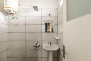 ein Bad mit einem Waschbecken und einem Spiegel in der Unterkunft Downtown Apartment by JadeCaps AC 2BHK Near CBD in Bangalore