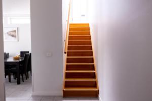 a wooden staircase in a room with a table at The Apollo in Apollo Bay