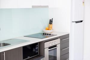 a kitchen with a sink and a stove top oven at The Apollo in Apollo Bay