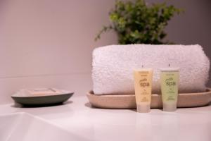 a couple of bottles of sunscreen sitting on a counter at The Apollo in Apollo Bay