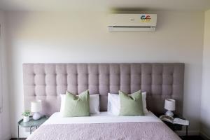 a bedroom with a large bed with a large headboard at The Apollo in Apollo Bay