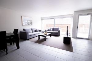 a living room with a couch and a table at The Apollo in Apollo Bay