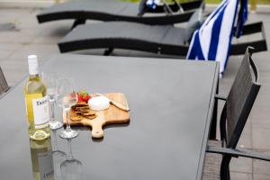 a table with a bottle of wine and wine glasses at The Apollo in Apollo Bay