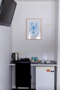 a kitchen with a desk with a spider on the wall at The Apollo in Apollo Bay