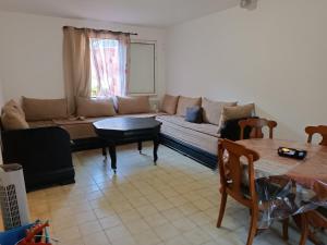 a living room with a couch and a table at Villa Mont D'Or in Manosque +6 photos