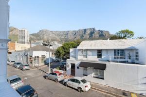 a city with cars parked in a parking lot at Victorian Townhouse with Table Mountain Views in Cape Town