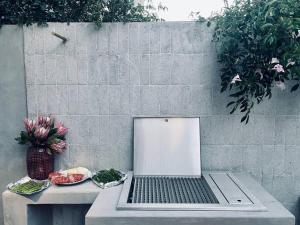 a laptop computer sitting on a table next to a wall at Victorian Townhouse with Table Mountain Views in Cape Town