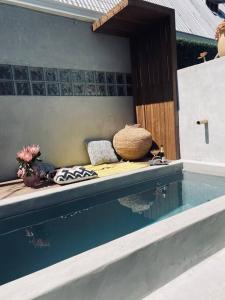 a bed sitting next to a pool of water at Victorian Townhouse with Table Mountain Views in Cape Town