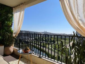 a balcony with a table and a view at Appartement - Duplex Sacré coeur in Paris