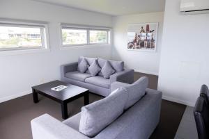 a living room with two couches and a coffee table at The Apollo in Apollo Bay