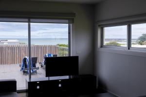 een kamer met een woonkamer met uitzicht op de oceaan bij The Apollo in Apollo Bay