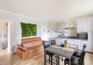 a kitchen and living room with a table and a couch at RESIDENCE MARATTA 54 in Terni