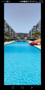 a large pool of blue water in front of buildings at فنادير in Hurghada