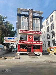 a building with a sign that reads superstar chicken wings restaurant at Rithikha Inn Crest in Chennai