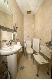 a bathroom with a sink and a toilet and a mirror at فندق منارة الكرام in Mecca