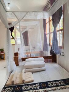 a bedroom with two beds with towels on it at Karibu Africa Home in Moshi