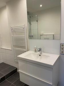 a white bathroom with a sink and a mirror at Ferienwohnung Lara in Bad Breisig