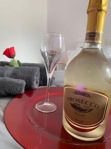 a bottle of wine and a glass on a table at B&B Suite "Caniglia" in Mesagne