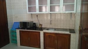a kitchen with a sink and a microwave at Bamboo House BnB in Bondeni +12 photos