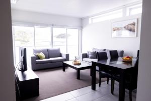 a living room with a couch and a table at The Apollo in Apollo Bay
