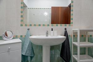 a bathroom with a sink and a mirror at CASA PATTI in Livorno