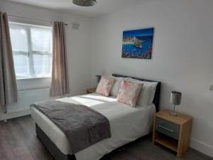 a bedroom with a bed and a window at Mountain Aven Guest House in Doolin