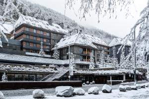 a large building with snow on the roof at Hotel Val de Neu G.L. in Baqueira-Beret