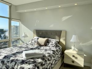 a bedroom with a bed and a large window at Luxury Homestay in Toronto