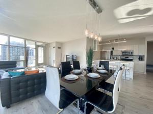 a kitchen and dining room with a table and a couch at Luxury Homestay in Toronto