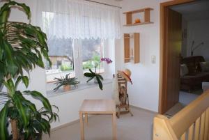 a living room with a table and a window at Beckerhof - ABC54 in Dorf Mecklenburg