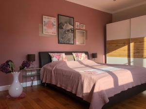 ein Schlafzimmer mit einem Bett und einer Vase mit Blumen in der Unterkunft Stadtvilla Brügemann - ABC136 in Wismar