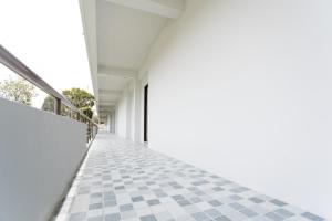a white building with a checkered floor at MountainviewKhaoyai in Ban Khanong Phra Klang (1)
