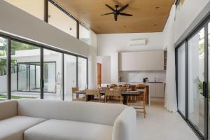 an open living room with a white couch and a table at The Villa Coco in Koh Samui 