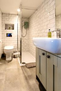 a bathroom with a sink and a toilet at The Old Granary Seahouses in North Sunderland +12 photos