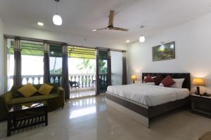 a bedroom with a bed and a balcony at Sal Riviera in Cavelossim