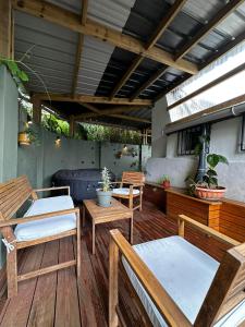 a patio with chairs and tables on a wooden deck at Ti kaz cannelle in Saint-Louis +6 photos