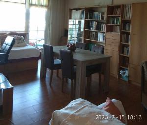 a living room with a table and chairs and a bedroom at Carte Postale in Kastoria