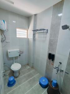 a bathroom with a toilet and a shower at Heritage Palace - Bhuj in Bhuj