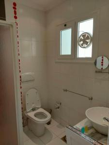 a bathroom with a toilet and a sink at Herrmes Hostel in Sharm El Sheikh