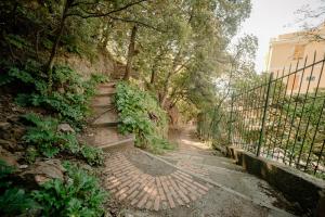 a stone path with stairs next to a fence at Fiordarancio Room Rental in Monterosso al Mare