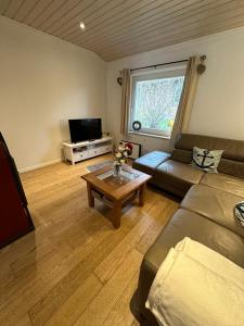 a living room with a couch and a coffee table at Ferienhaus Lönnehus in Fehmarn
