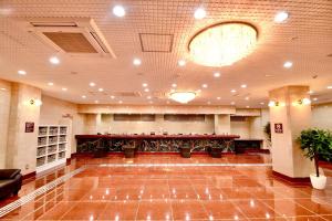 a large lobby with a bar in the middle at Himeji Ekimae Universal Hotel Minamiguchi in Himeji