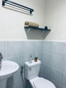 a bathroom with a toilet and a sink at RichAirbnb Cebu in Lapu Lapu City