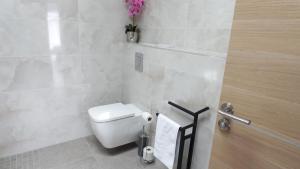 a bathroom with a toilet and a toilet paper dispenser at VILLA Ô Chris spacieuse, 2 Terrasses, 1 SPA, à 15 mn de Marseille, de la Côte bleu et Aix en Provence in Saint-Victoret
