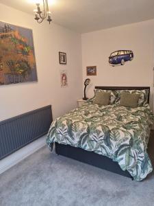 a bedroom with a bed with a car on the wall at Todmorden Bed & Breakfast - The Toothless Mog in Walsden