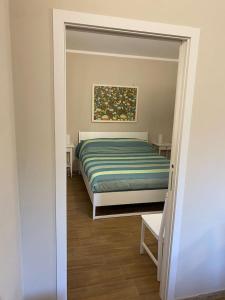 a bedroom with a bed and a painting on the wall at Casa di Chiara in Pisticci