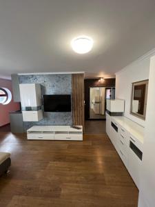 a kitchen with white cabinets and a counter top at Holiday Apartments in Krynica Zdrój