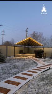 a gazebo with lights on it in the snow at Rauda home in Uralʼsk